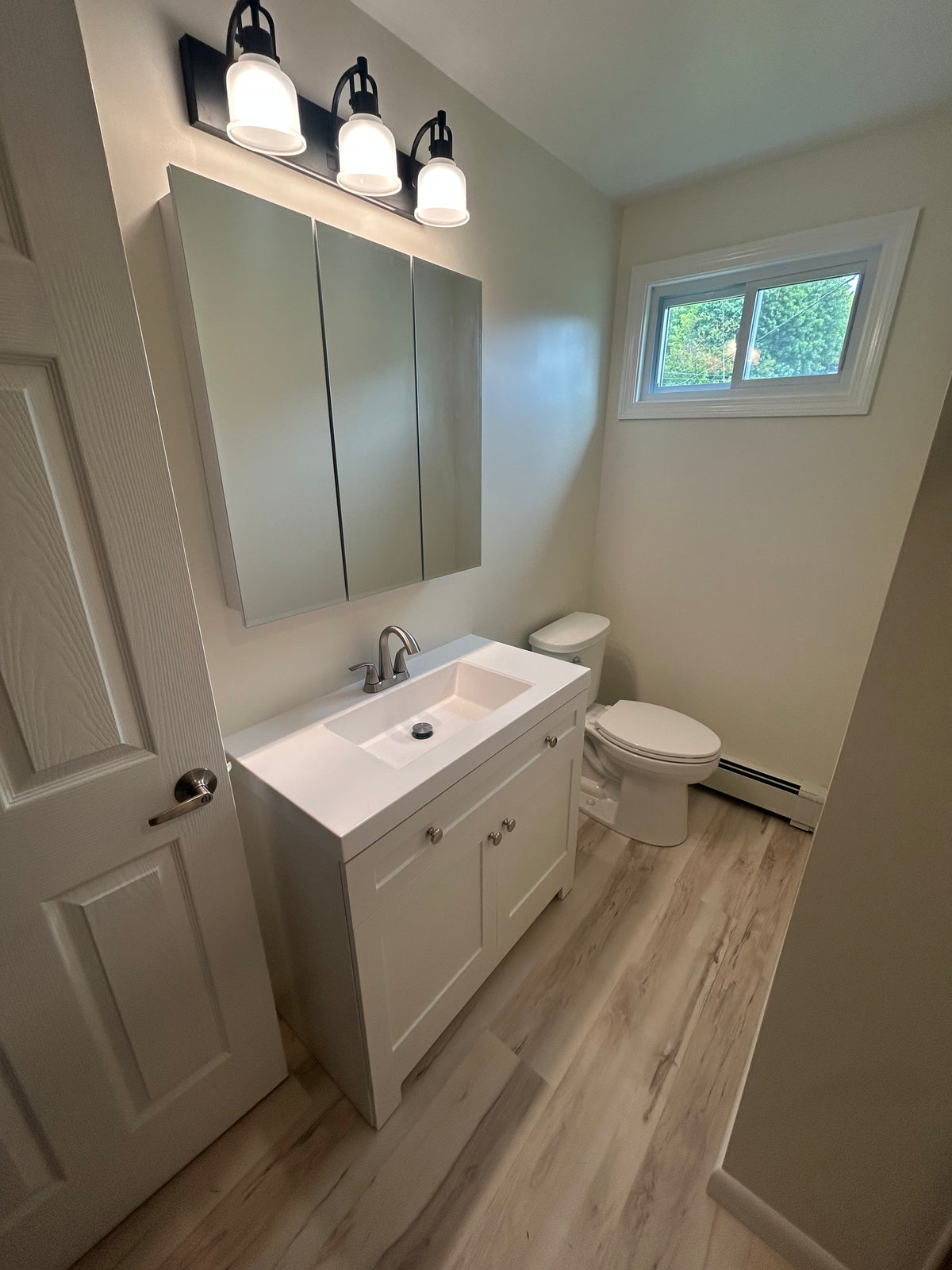 Master bathroom renovation in Naugatuck CT with tiled walk-in shower, new vanity, and updated lighting by Hogan's Handyman Services. — Hogan’s Handyman Services